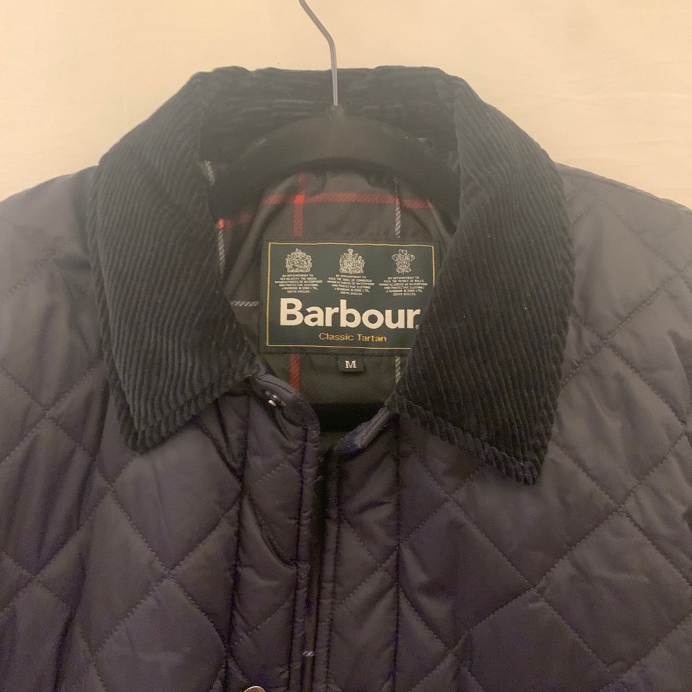 Men’s quilted Barbour coat with corduroy collar.